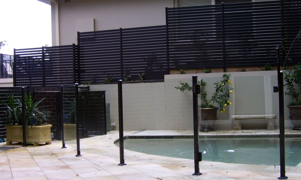 Semi-frameless glass pool and slat fencing